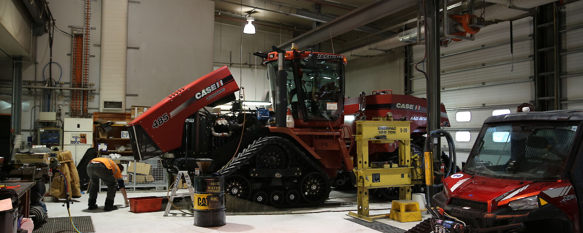 Station mechanical workshop with large tracked vehicles inside a giant shed