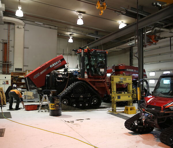 Station mechanical workshop with large tracked vehicles inside a giant shed