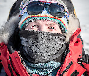 Expeditioner dressed in warm Antarctic clothing, with only her eyes uncovered
