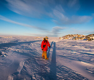 Expeditioner out walking across the vast snow