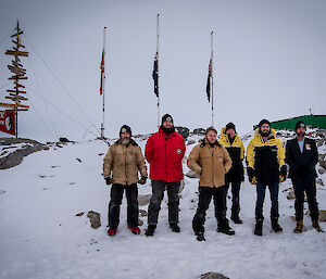Six expeditioners who are also ex-servicemen gather on the ice for Anzac day