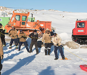 Expeditioners hauling in rescue craft