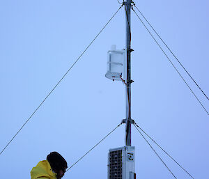 Expeditioner removes ice from instrument solar panel