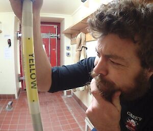 Expeditioner cleaning station stares intently at mop handle