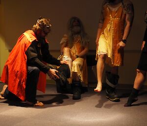Prince tries golden boot on men dressed as ladies in the play ‘Cinderfella'.