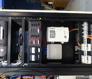 A tall server case filled with electrical equipment