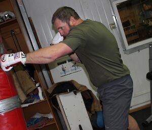 Expeditioner punches bag in the gym