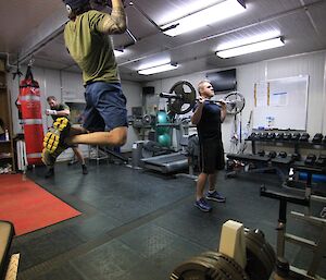 Expeditioners in the gym doing various exercises