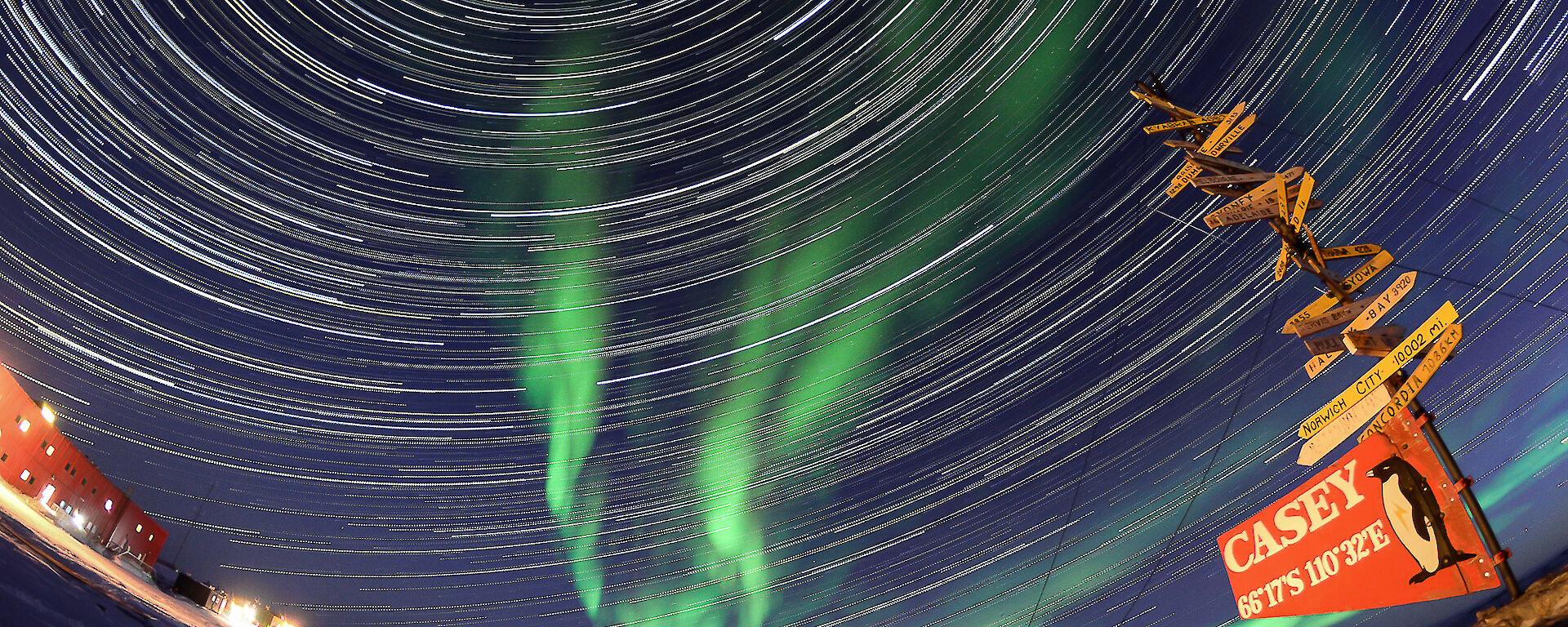 An aurora and incredible circular star trail, captured with timelapse photography, fill the sky above Casey station
