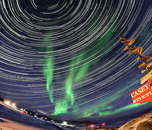 An aurora and incredible circular star trail, captured with timelapse photography, fill the sky above Casey station