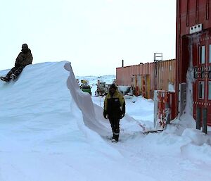 Expeditions sit atop a large snow bank