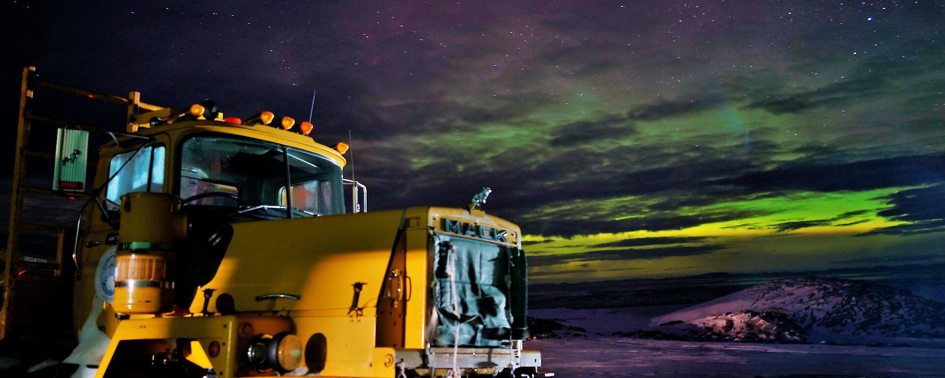 Aurora with large Mack truck in foreground