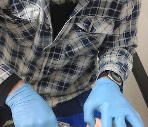 Expeditioners practice dentistry, a tooth extraction, on a dummy