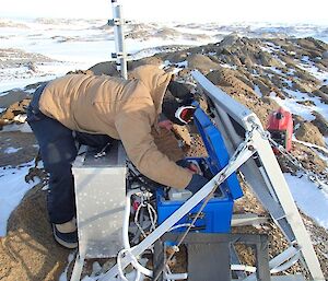 Expeditioner checking radio batteries