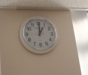 A clock high up on the wall shows the time of 1pm.