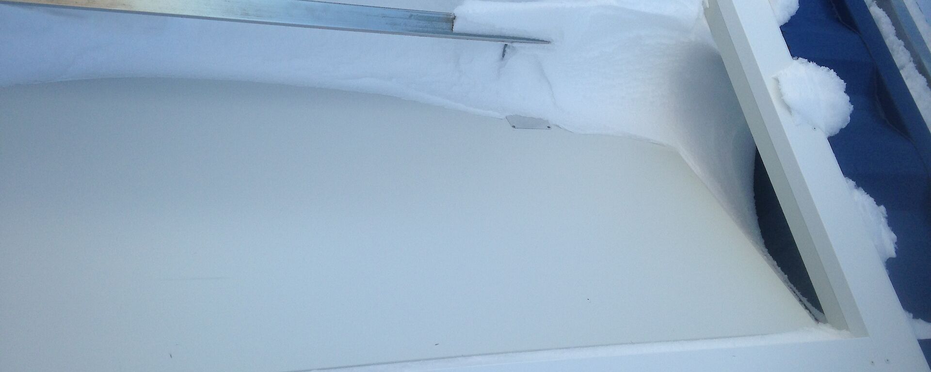 Door on building blown in by blizzard