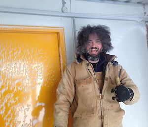 Expeditioner watches on as snow is shoveled.