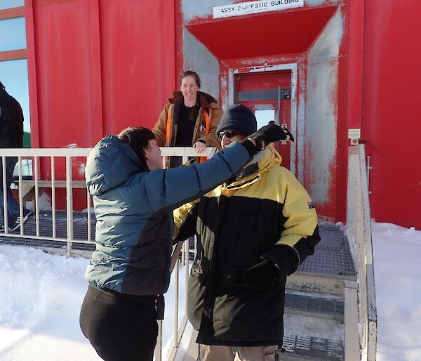 Expeditioner hugs her colleague before departing station