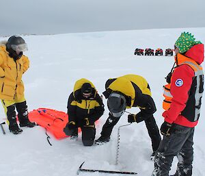 Expeditioners measuring ice thickness