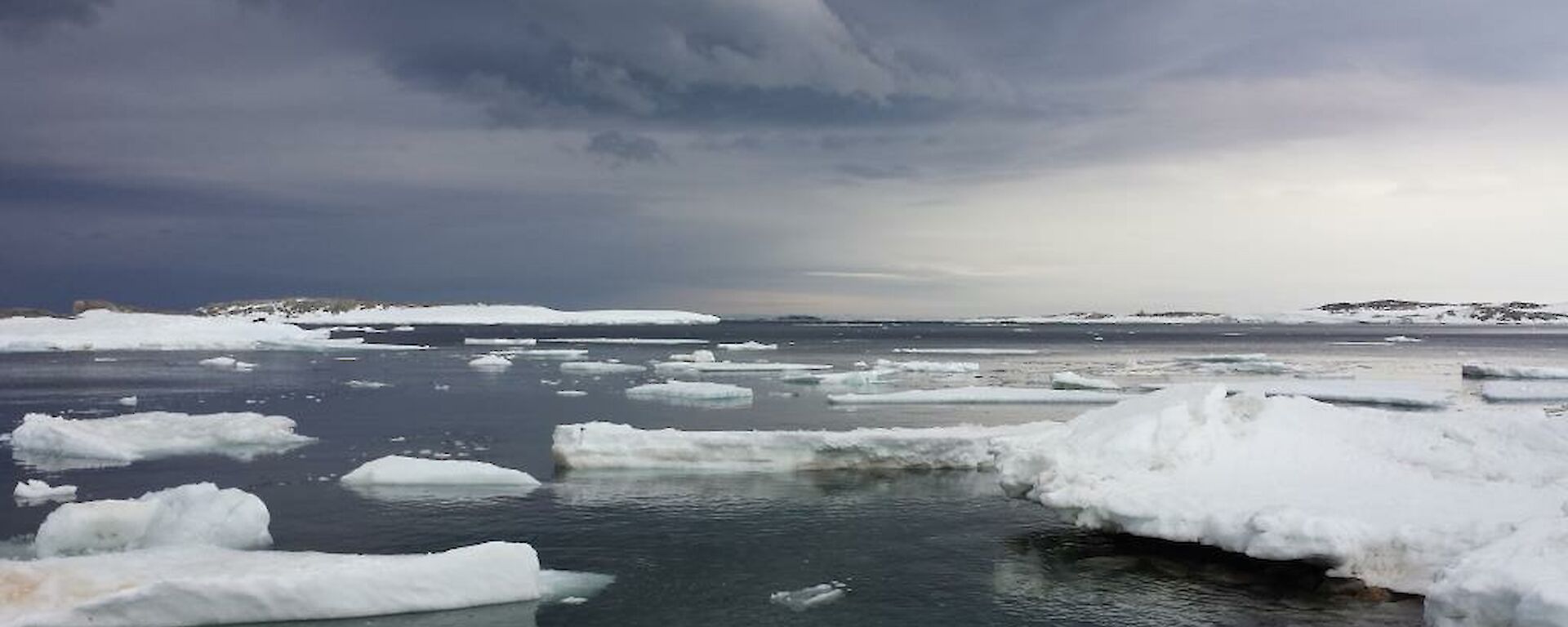 View from wharf hut which looks over the sea ice and water — beautiful