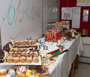 A large table of desserts and puddings with “Christmas at Casey” written on the whiteboard behind