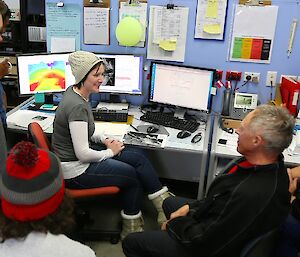 Forecaster providing a weather briefing for an attentive audience