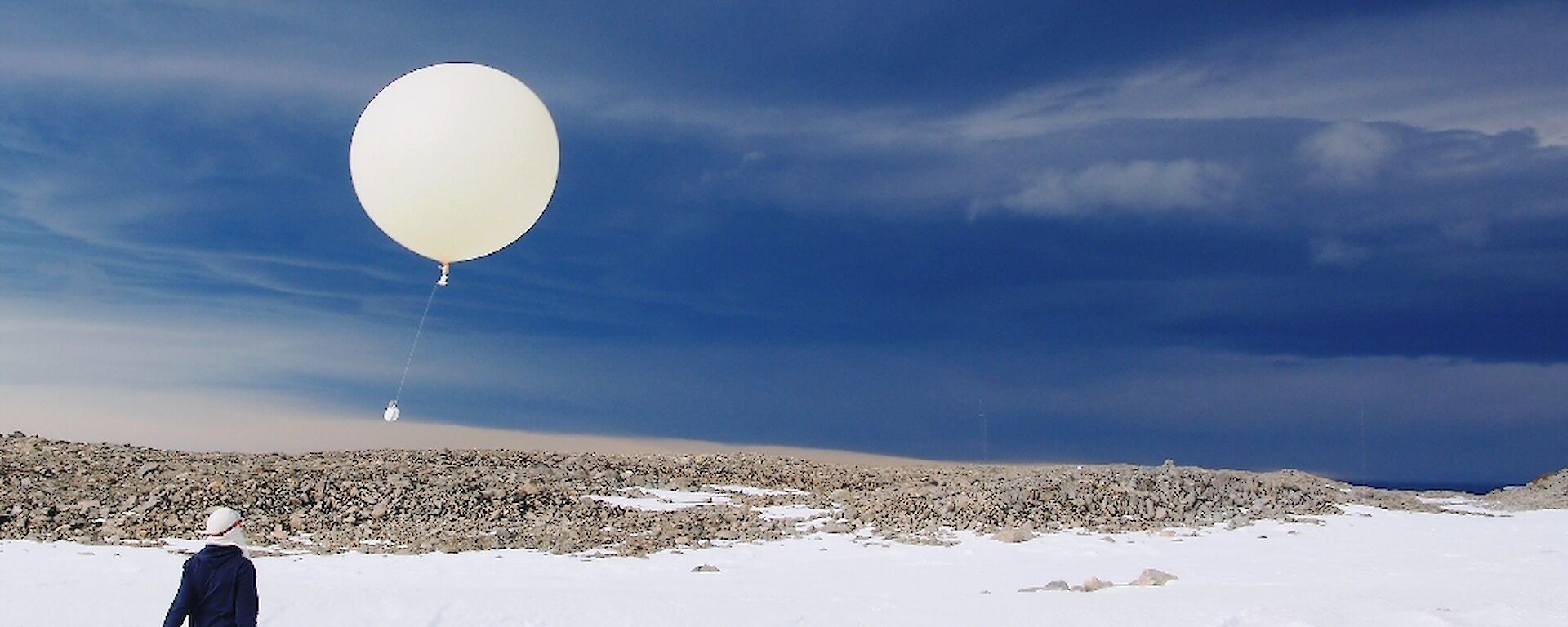 Balloon release against a threatening sky