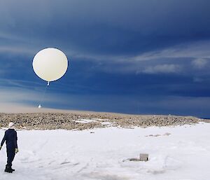 Balloon release against a threatening sky