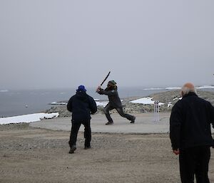 Expeditioners playing cricket on Casey’s waterfront. The day is overcast and looks cold.