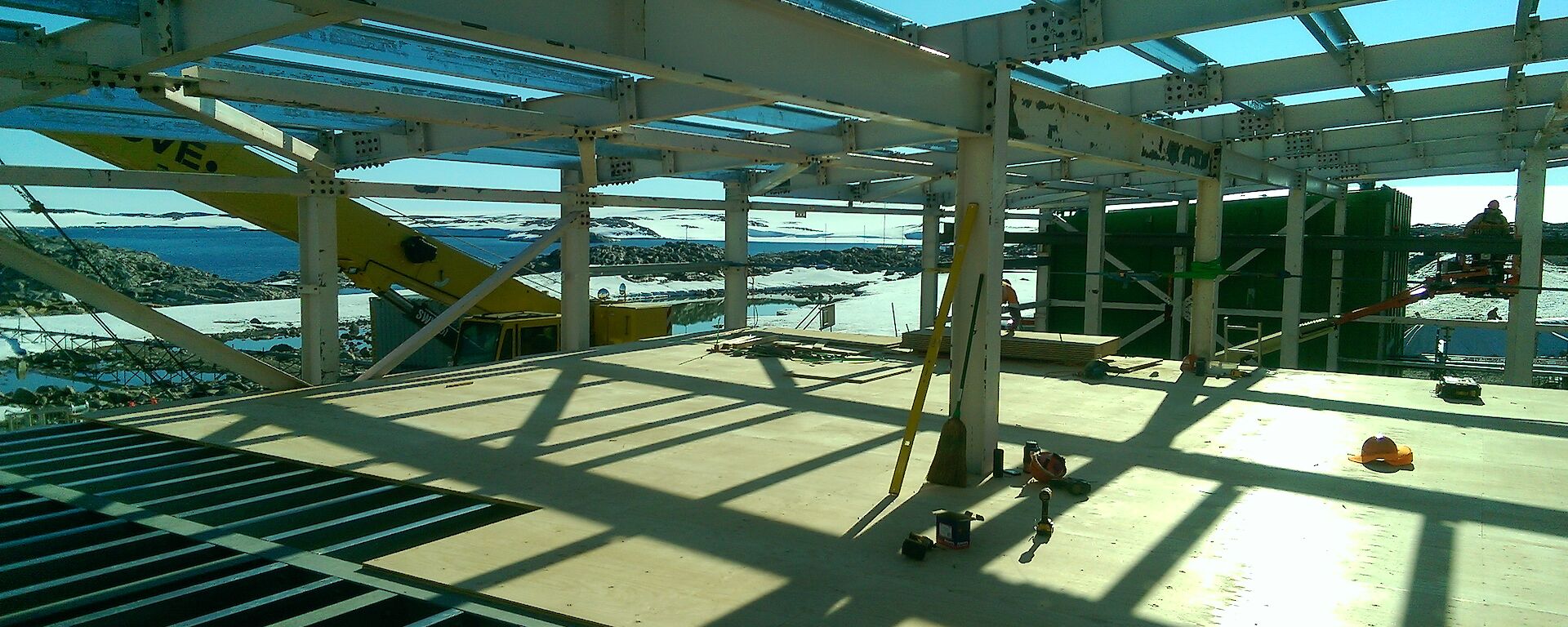 A building is being constructed and Antarctic scenery is viewable through it