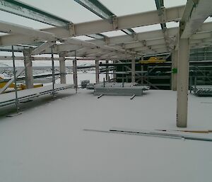 Inside a new construction zone, a building is covered in snow.