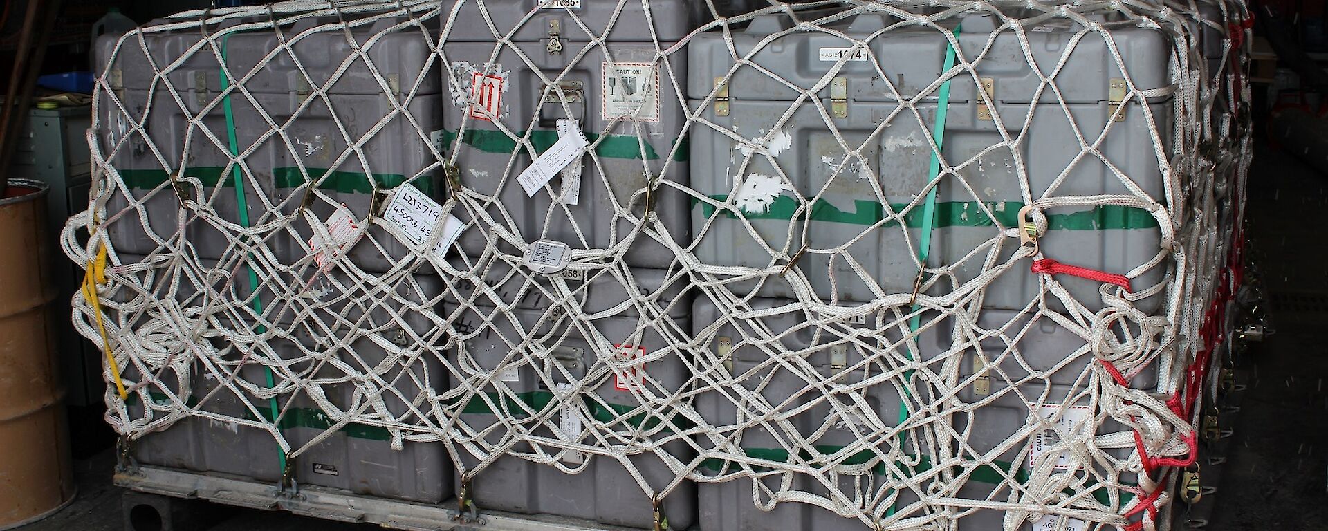 Cargo wrapped up in netting and sitting inside a shipping container