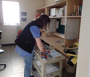 Rachel laying out all the brightly coloured Easter eggs that have been found on a trolley so she could count them.