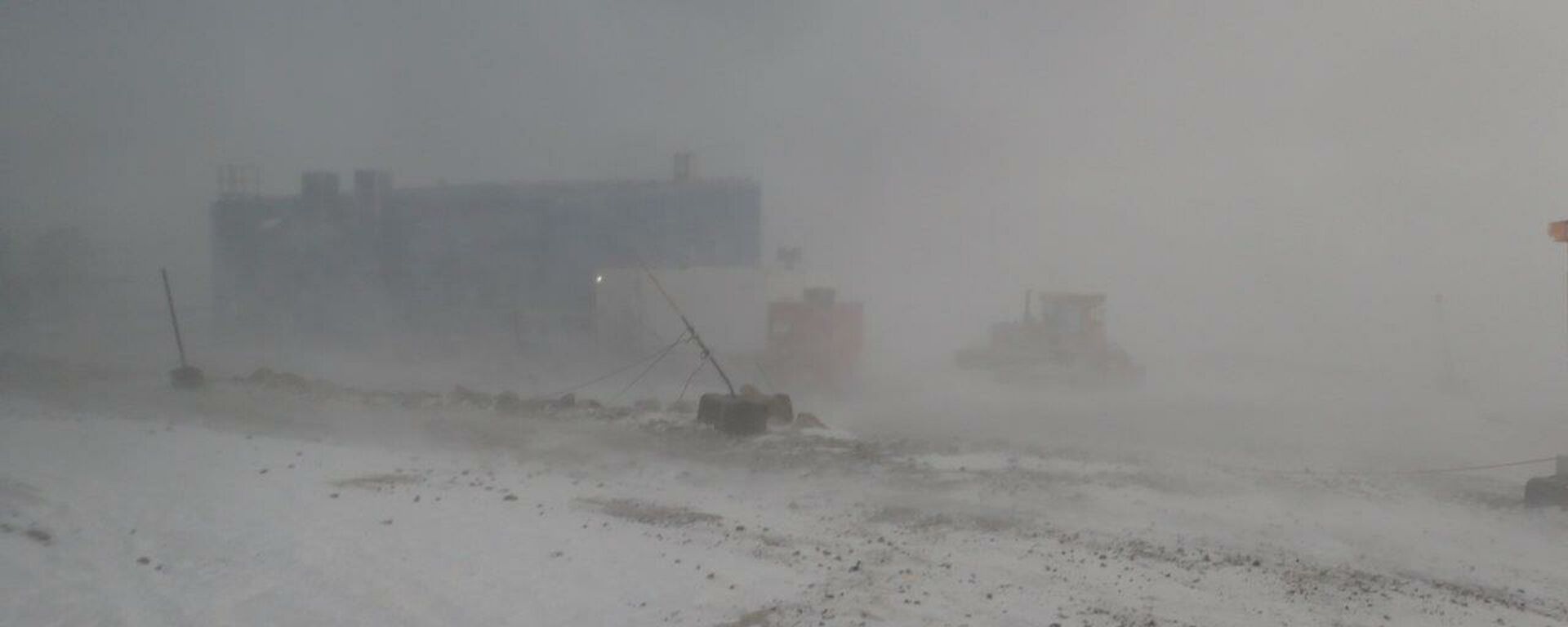 Looking out at towards the main power house from the Red Shed with blowing snow reducing visibility.
