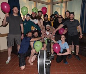 Team photo for completing Million Meter Marathon Row, all participants have their hands touching, and some are holding balloons with the words ‘Huntington’s New South Wales'