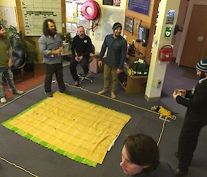 The group watching Andrew count his winnings after a successful round in the center of the two up ring.