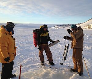 Mick holding the retrieved sampling tube with Nick holding the rope board and Steve watching on.