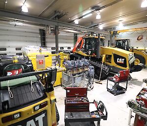 Photo of inside the Casey mechanical workshop full large and small equipment ready for winter maintenance.