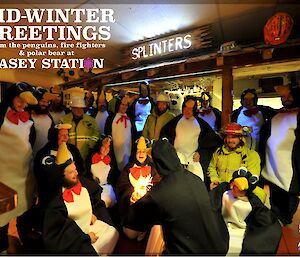 Casey expeditioners dressed in penguin suits and firefighting turn out clothing in the wallow made for a fun photo for the Station midwinter greeting.