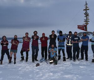 Those on station who are from QLD and NSW posing in front of the Casey sign in their maroon and blue colours.