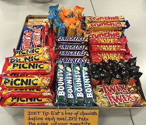 Chocolate bars all arranged nice and neatly in a tray with a little diet tip: “Eat a bar of chocolate before each meal, it’ll take the edge of your appetite and you’ll eat less”.