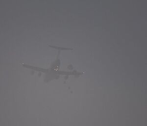Three parachutes open as the parcels are dropped from the C-17.