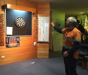 Cam playing a game of darts.
