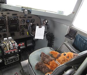 Walter (stuffed soft toy) sitting in the pilot’s seat of a Ken Borek Air Basler aircraft.
