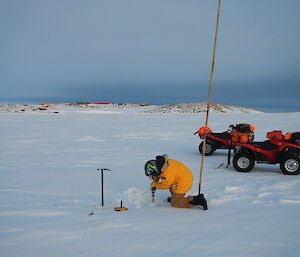 Jeff drilling the ice with the drill shaft almost gone as the ice is over 1 metre thick.