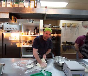 Matt kneading the dough for the bread he is making.