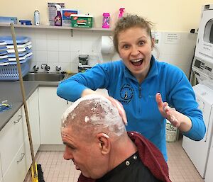 Katie getting ready to shave Andrews head after running the clippers over first.