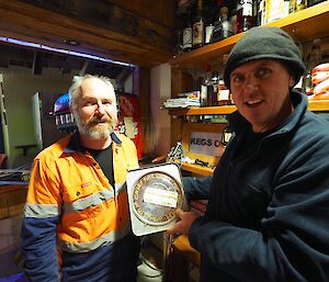 Marto and Cam with the metal tin found hidden in the bar construction during the refurbishment