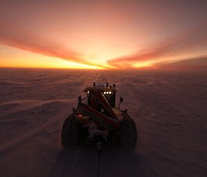 Photo taken from behind the tractor as it is heading towards a beautiful sunset.