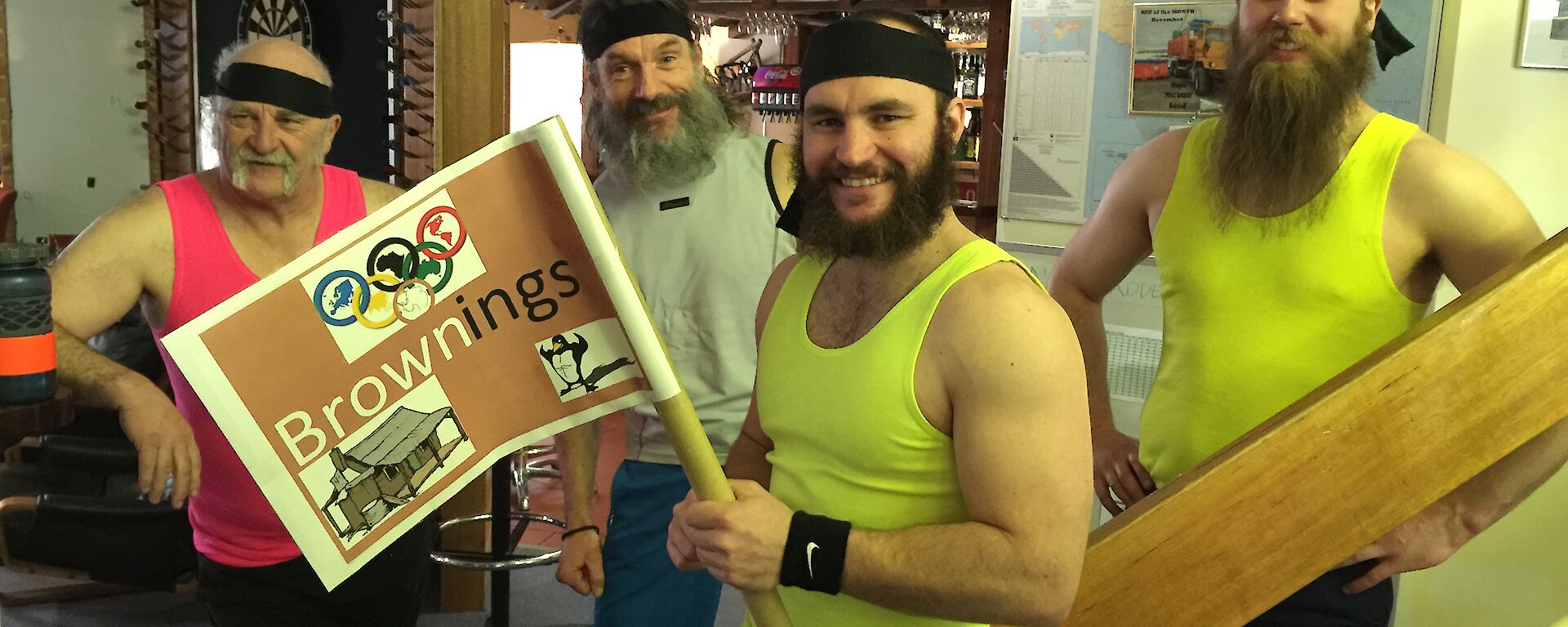 The Browning’s Olympic team posing in their fluro singlets with the captain holding the team flag.